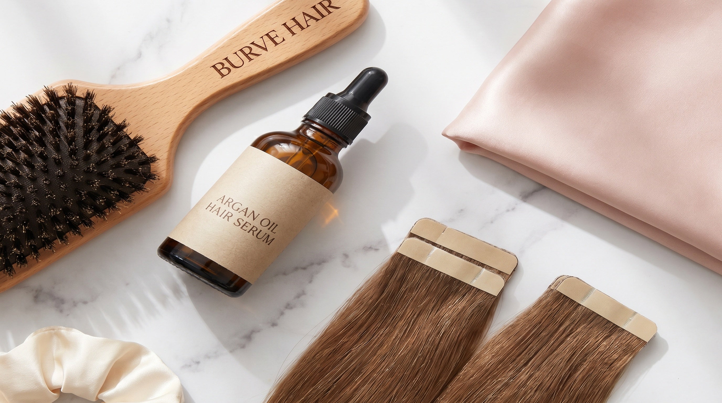 Hair extension care guide flatlay with Burve Hair brush, argan oil, and beige tape-in extensions